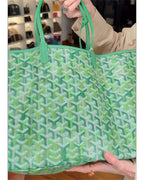 Green patterned tote bag close-up with two handles and open top