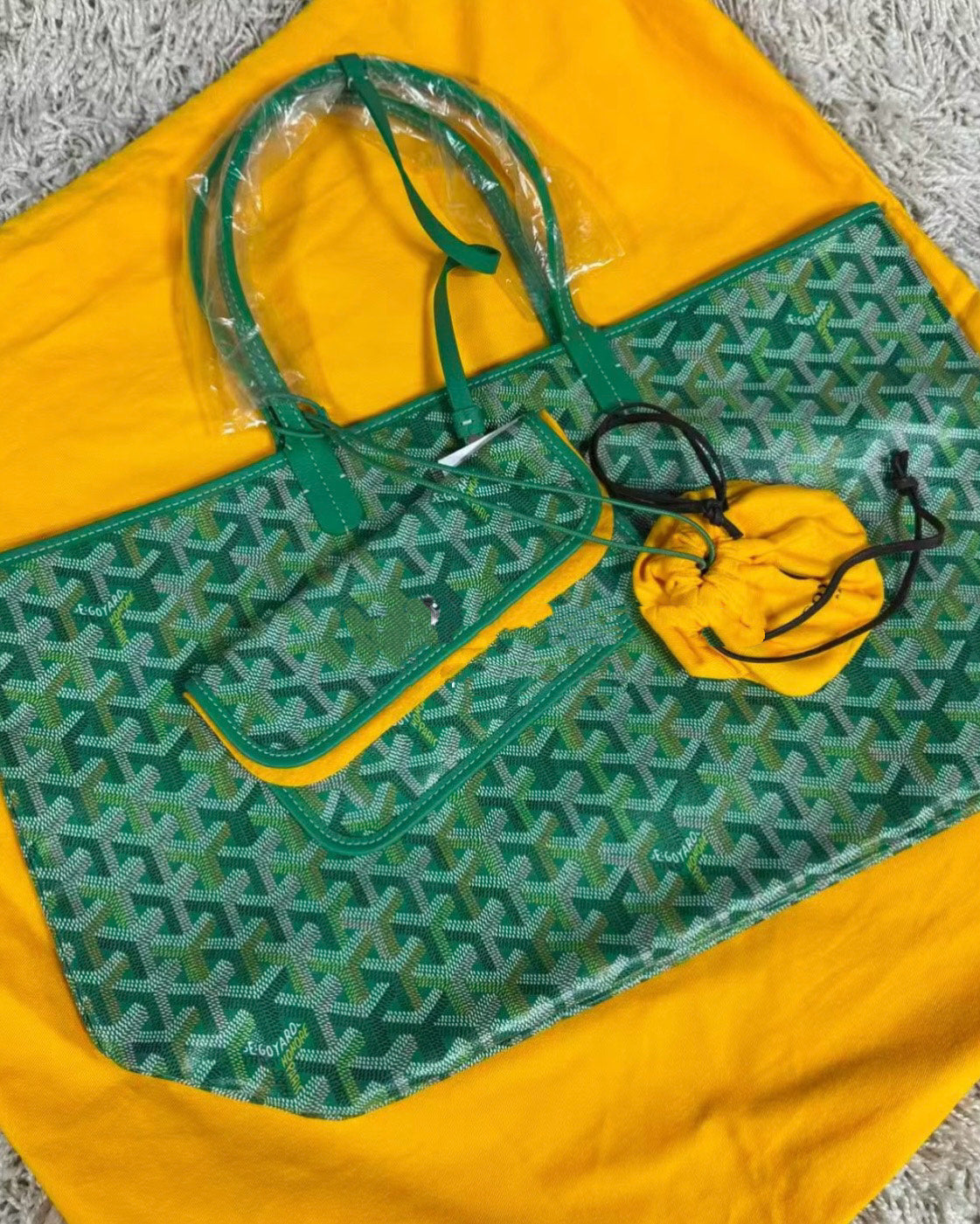 Green patterned tote bag with matching face mask pouch on yellow