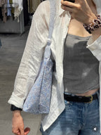 Light blue patterned hobo tote bag with zip-top and side fold