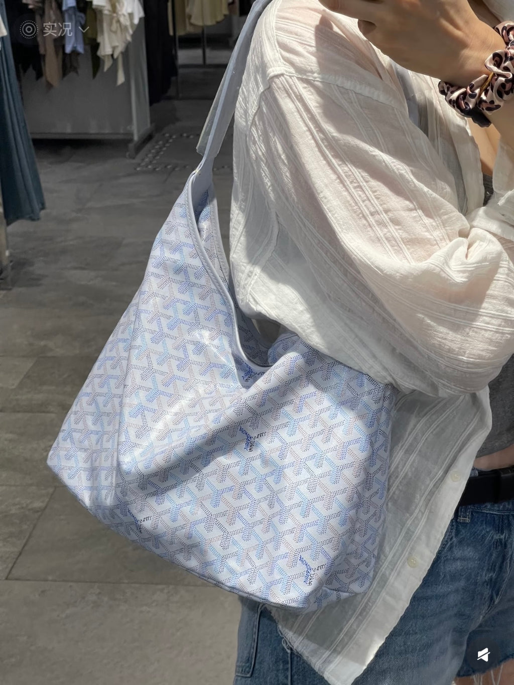 Light blue patterned tote bag with soft handles and zip-top opening