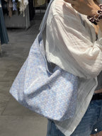 Light blue patterned tote bag with soft handles and zip-top opening
