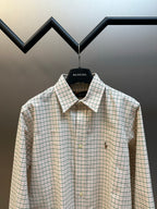 Plaid button-up shirt with spread collar and small embroidered chest accents.