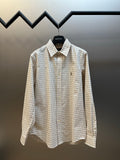 Plaid button-up shirt with pointed collar, long sleeves, front button placket.