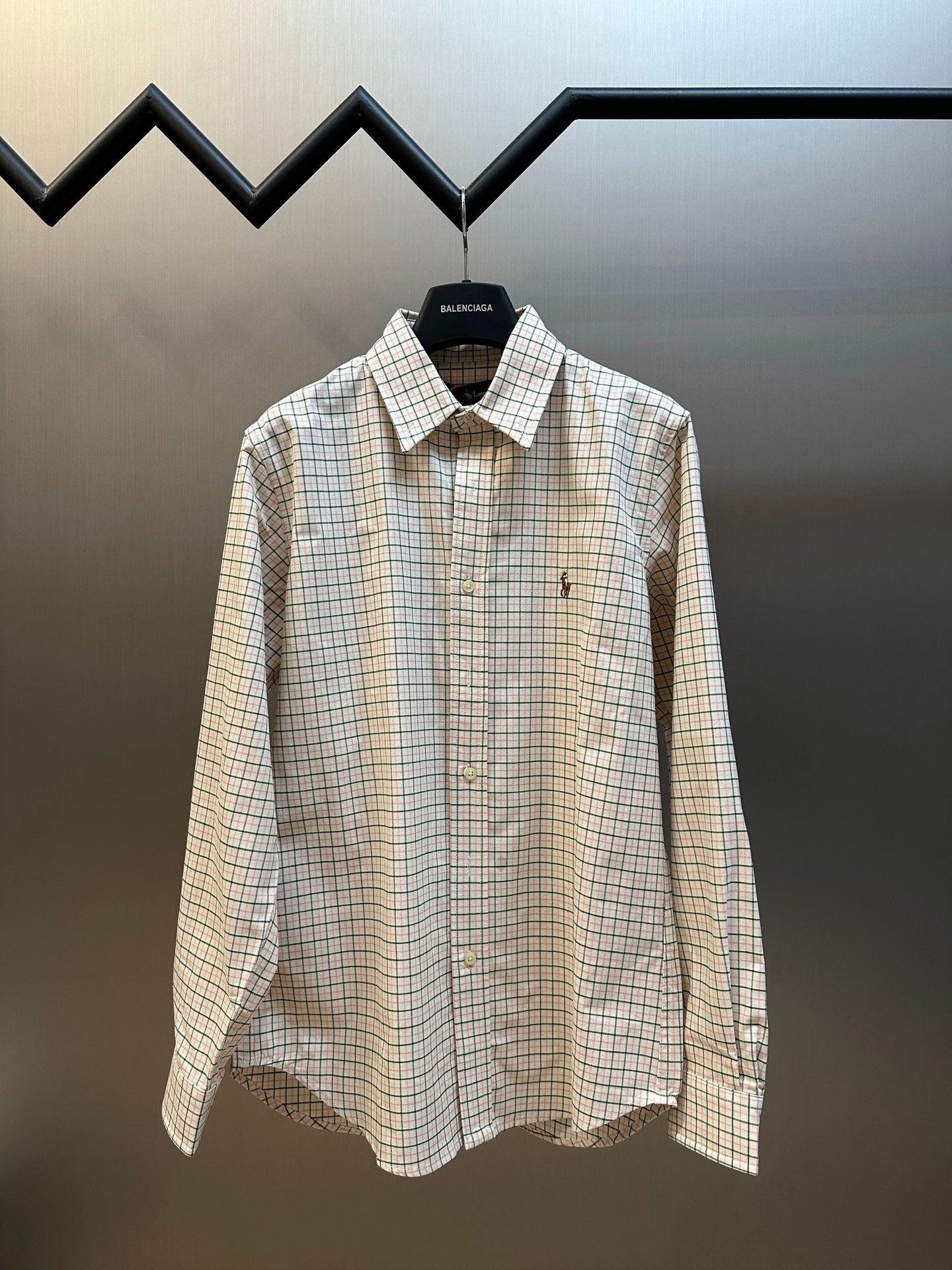 Plaid button-up shirt with pointed collar, long sleeves, front button placket.