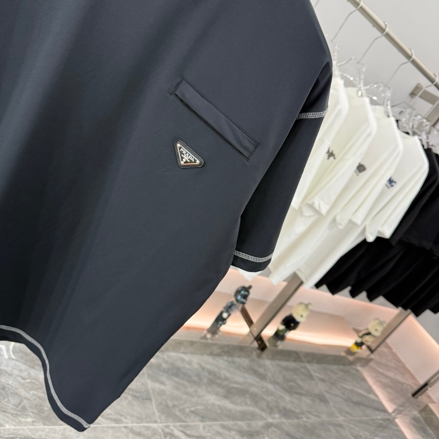 Prada short-sleeve T-shirt, dark navy, stitched hem trim, logo patch and chest pocket