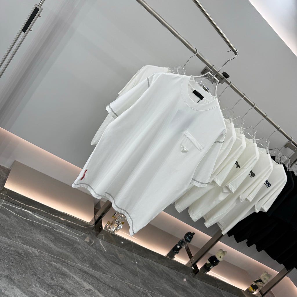 White short-sleeve T-shirt with small chest pocket and logo detail, on hangers