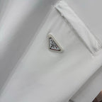 White T-shirt chest pocket with metal logo patch reading PRADA