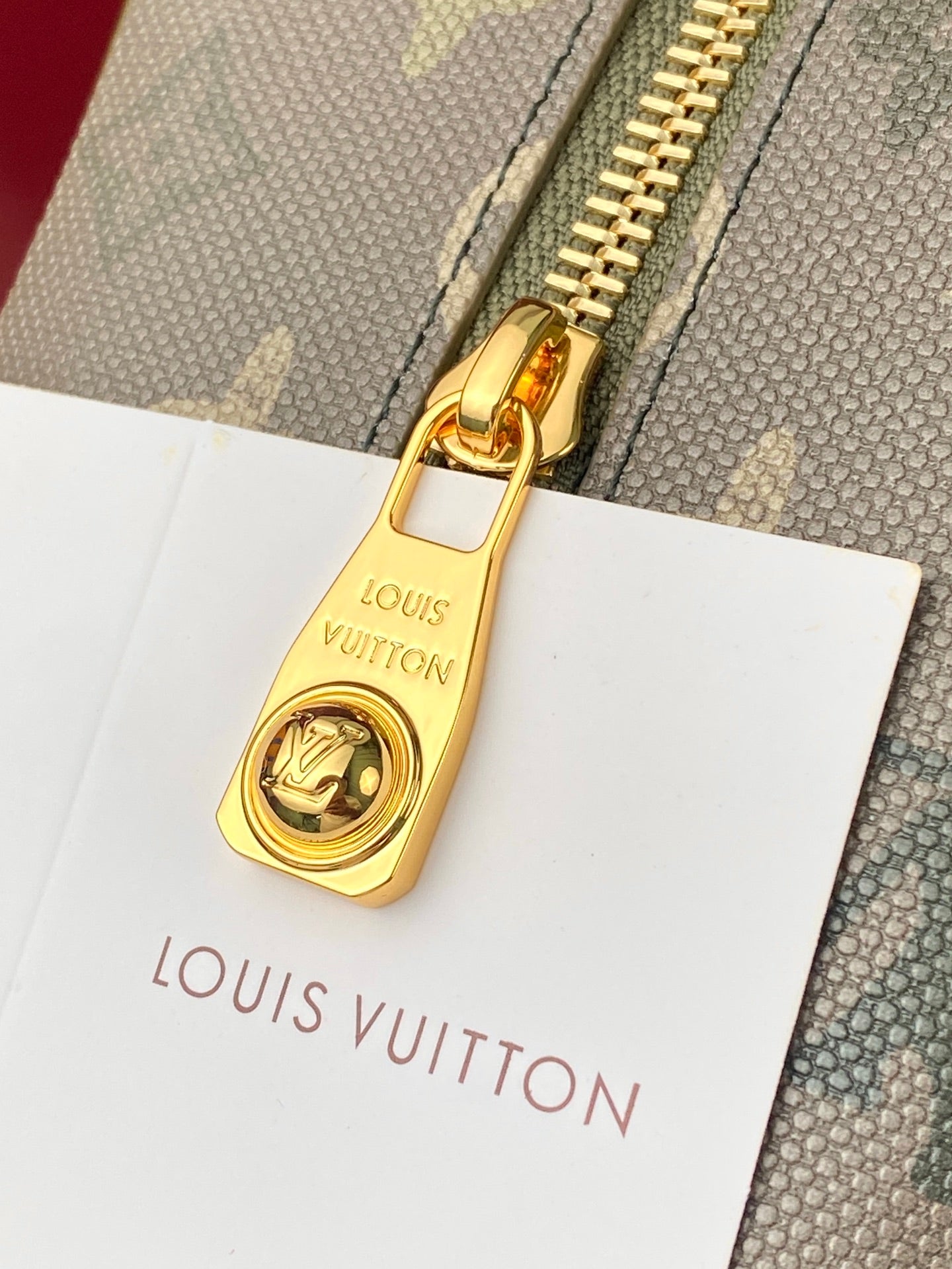 Small Louis Vuitton bag with gold padlock clasp and canvas logo front panel