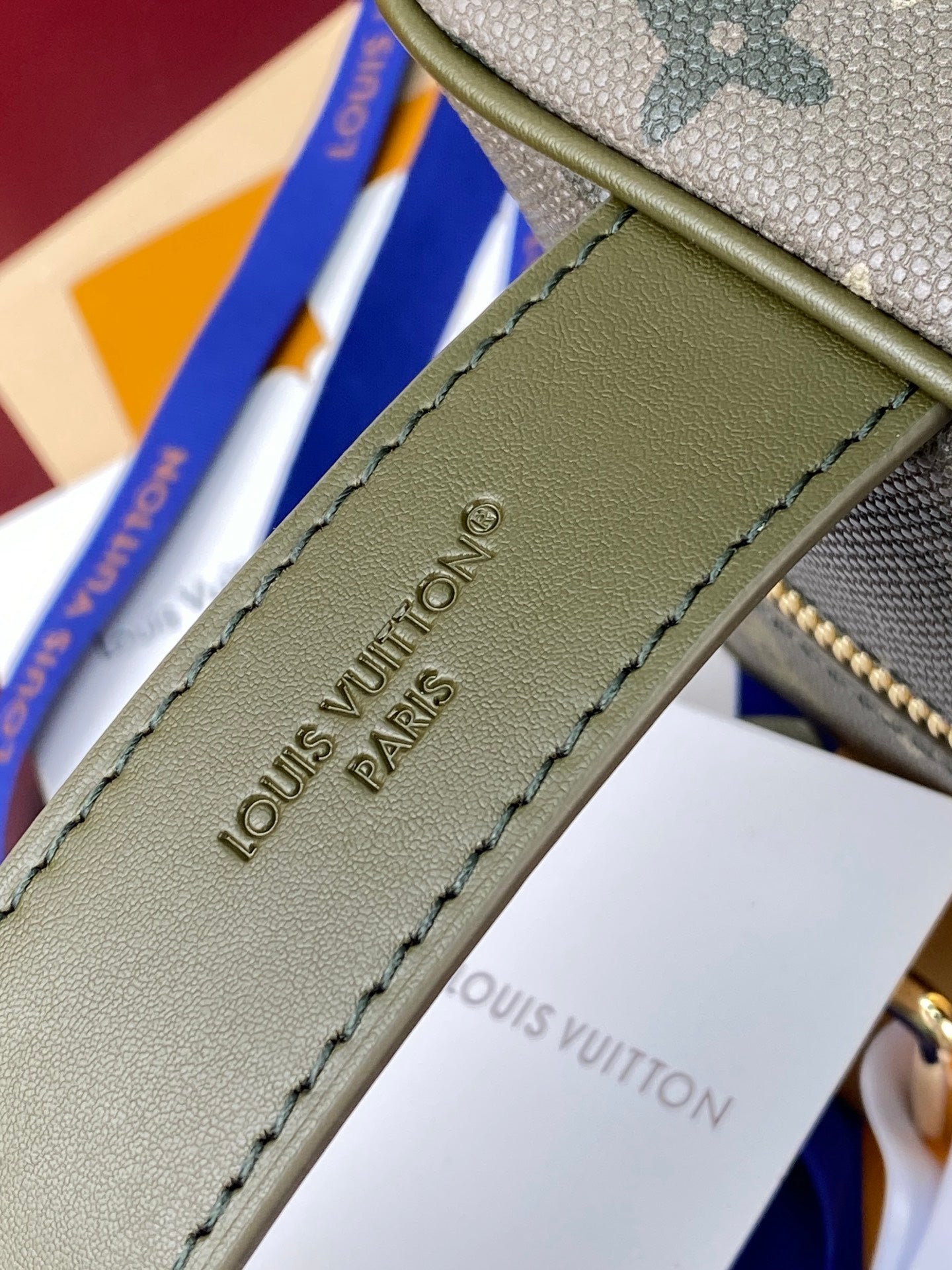 Olive leather strap with Louis Vuitton Paris text and contrast stitching