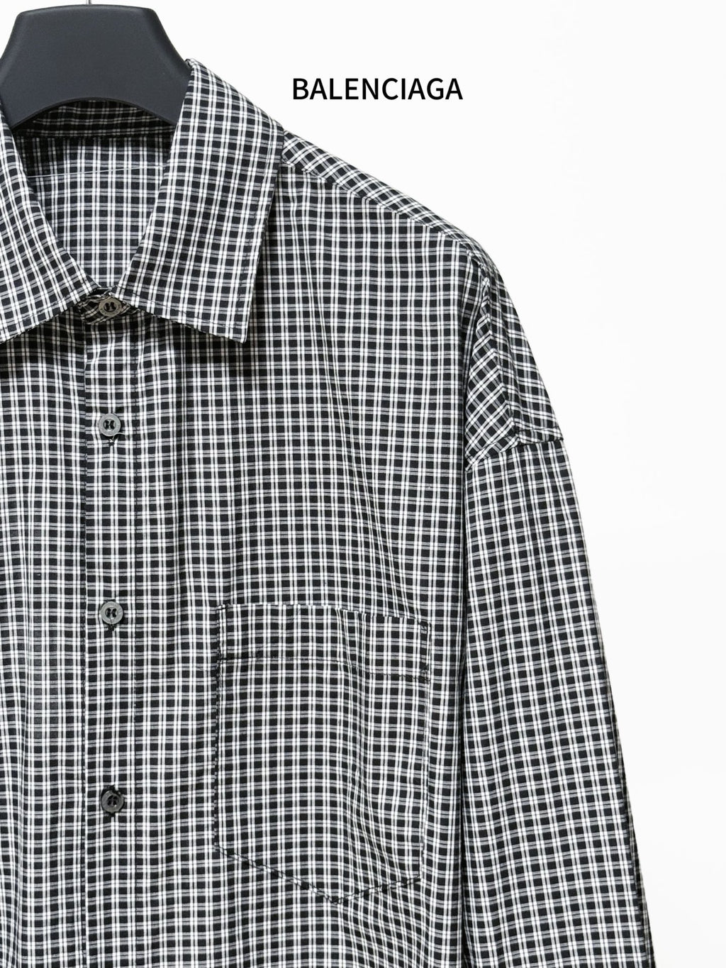 Checkered shirt detail with pointed collar and front button placket