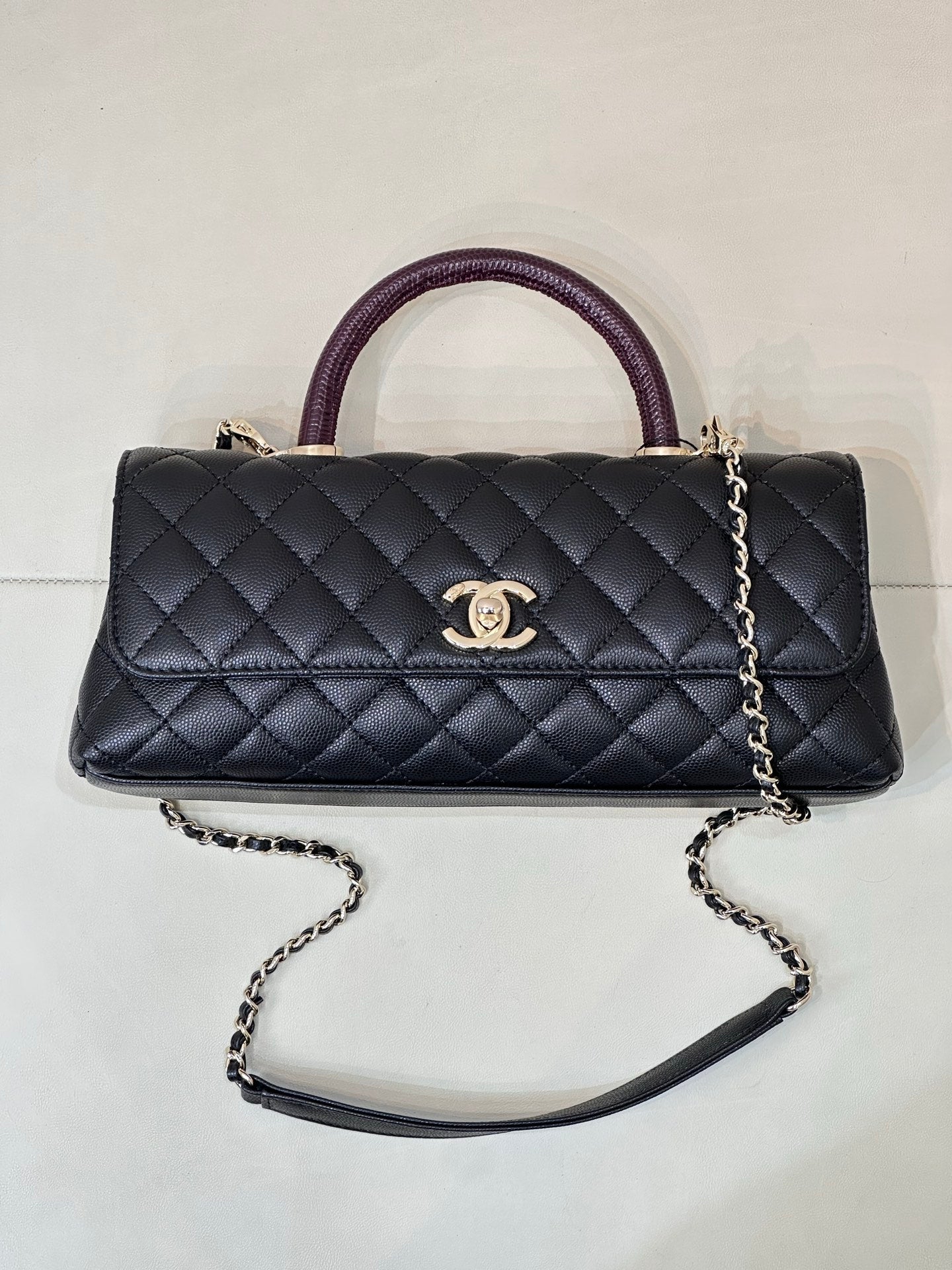 Chanel bag, dark navy quilted flap front with purple top handle and silver chain strap