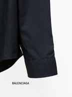 Dark long-sleeve shirt with wide sleeve cuff and relaxed hem