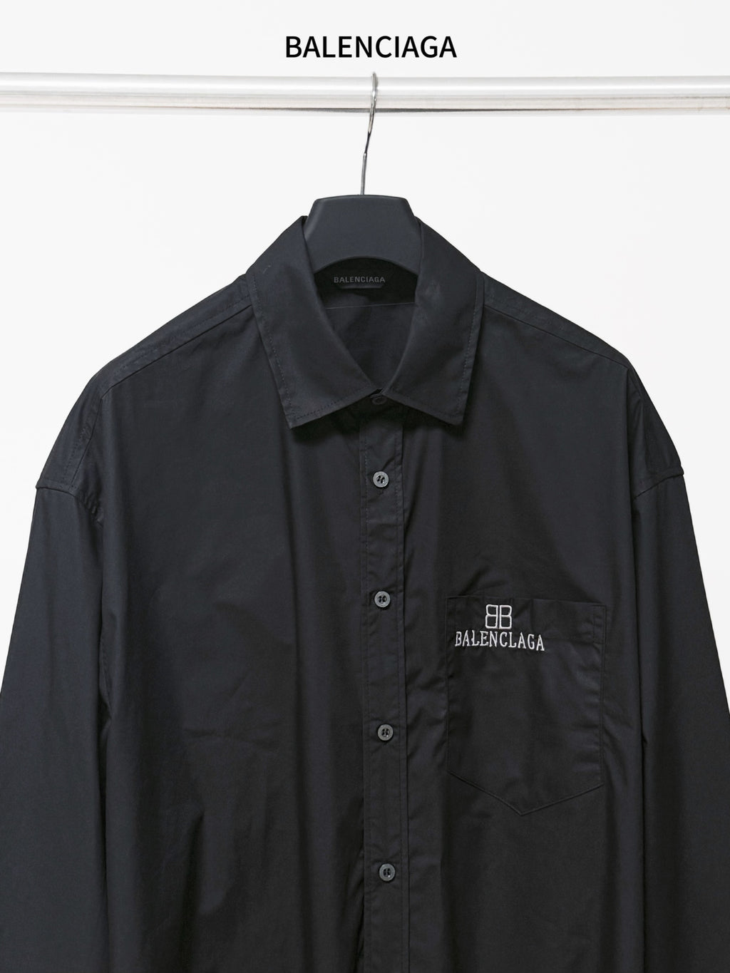 Dark long-sleeve button-up shirt with chest pocket and BALENCIAGA logo