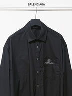 Dark long-sleeve button-up shirt with chest pocket and BALENCIAGA logo