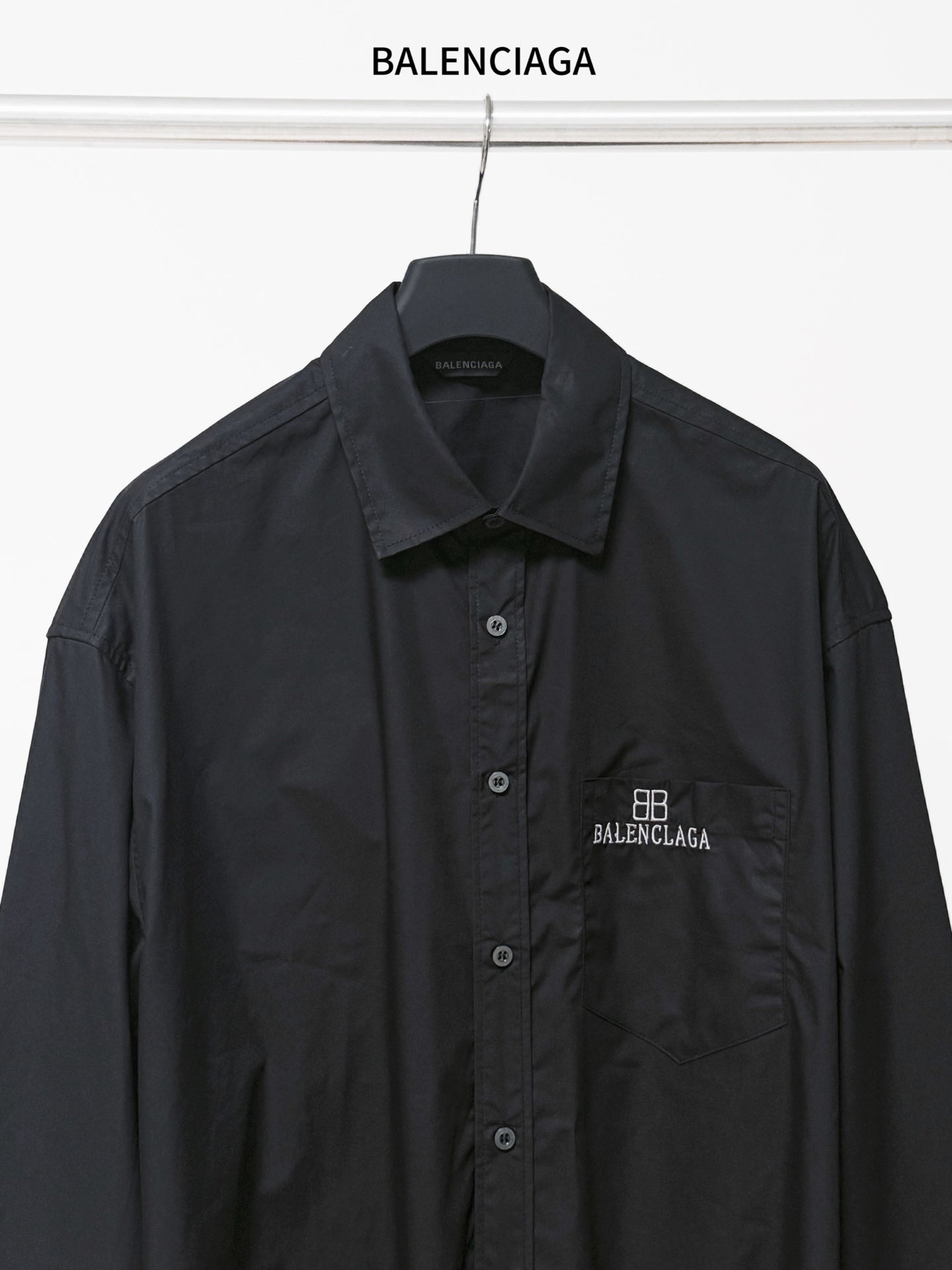 Dark long-sleeve button-up shirt with chest pocket and BALENCIAGA logo