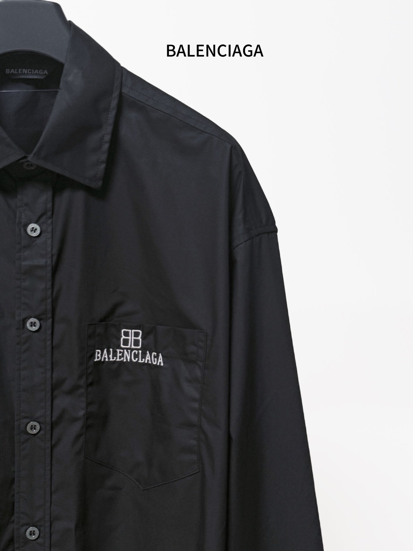 Dark long-sleeve shirt with front pocket and embroidered BALENCIAGA logo