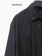 Dark long-sleeve button-up shirt close-up, point collar and button placket