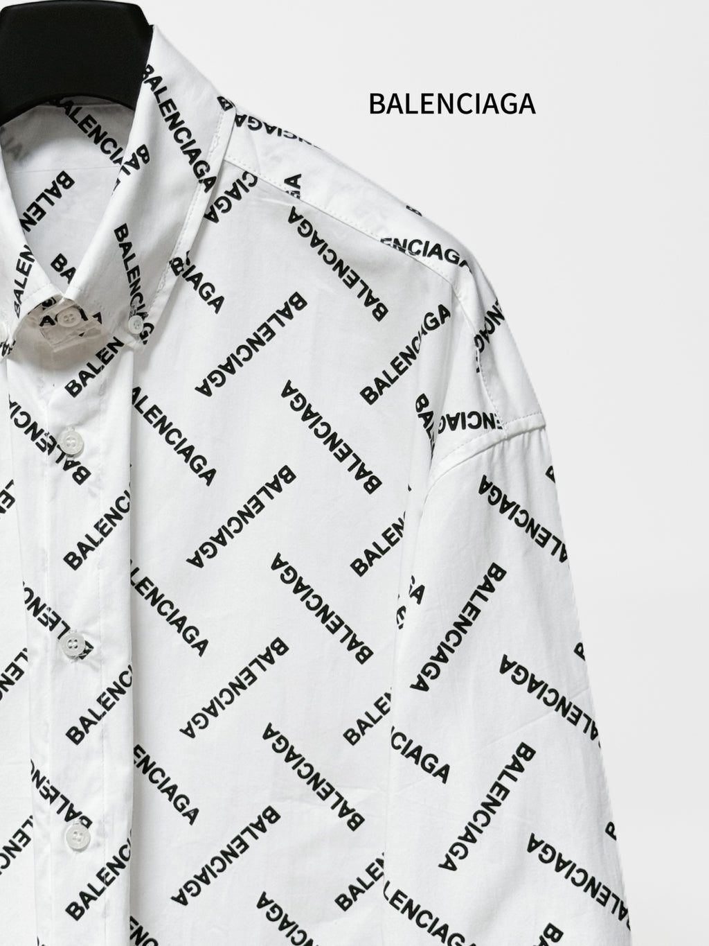 White long-sleeve button-up shirt with black Balenciaga logo print, side view