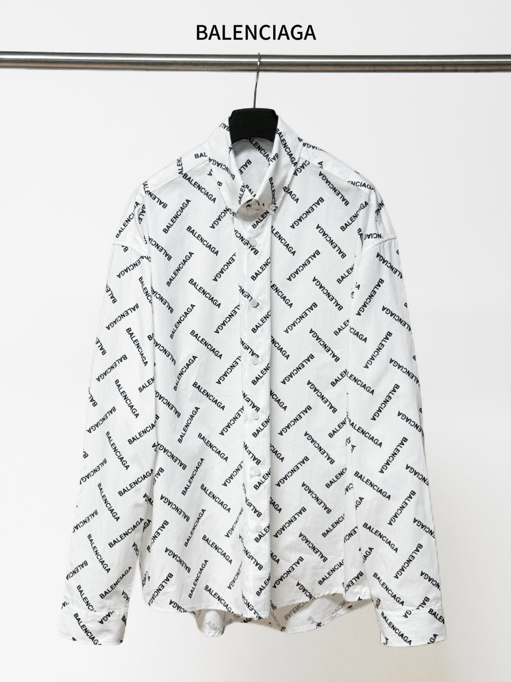 White long-sleeve button-up shirt with black Balenciaga logo allover print