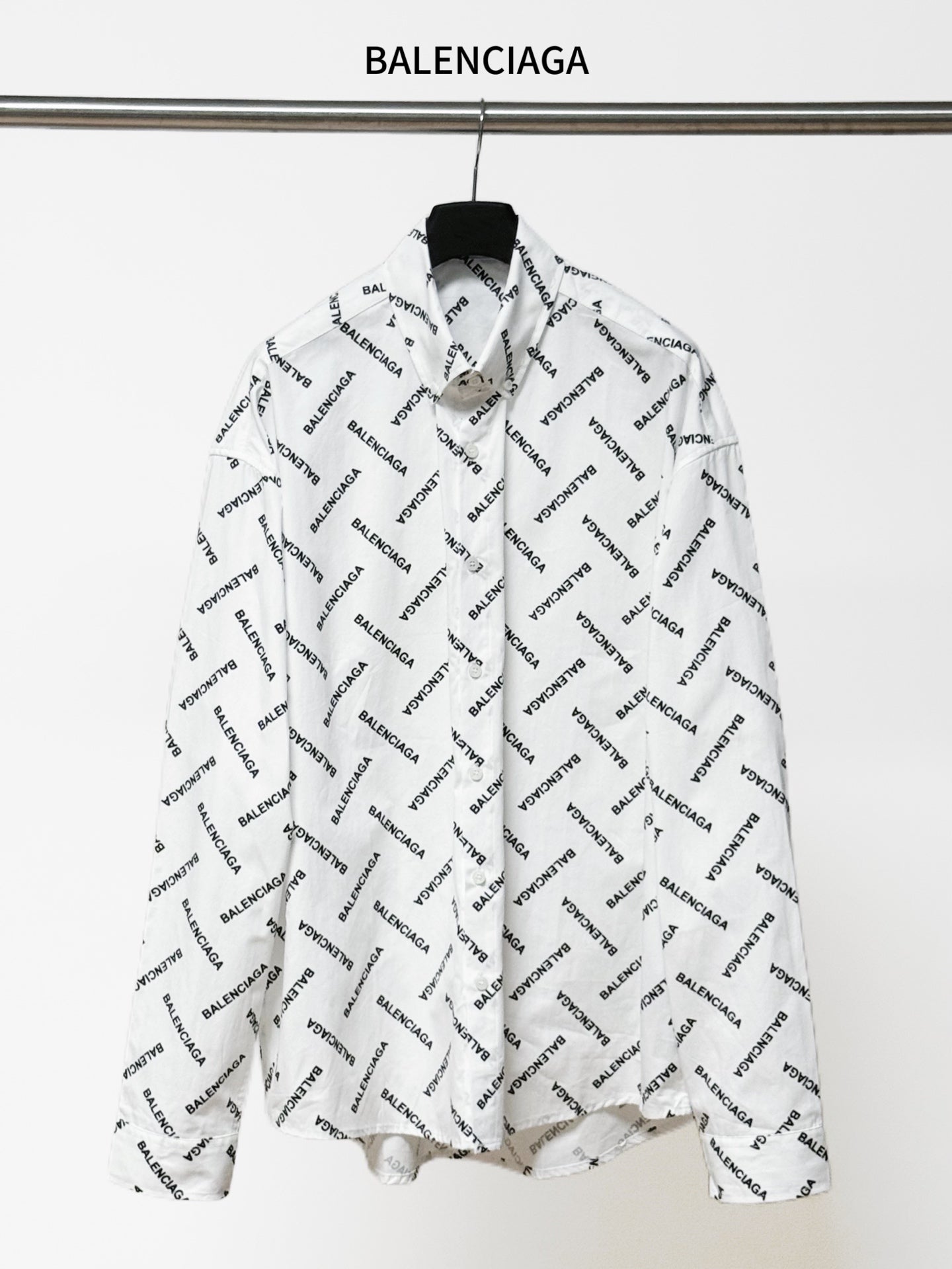 White long-sleeve button-up shirt with black Balenciaga logo allover print