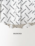 White long-sleeve button-up shirt lower front and hem with black Balenciaga logo print