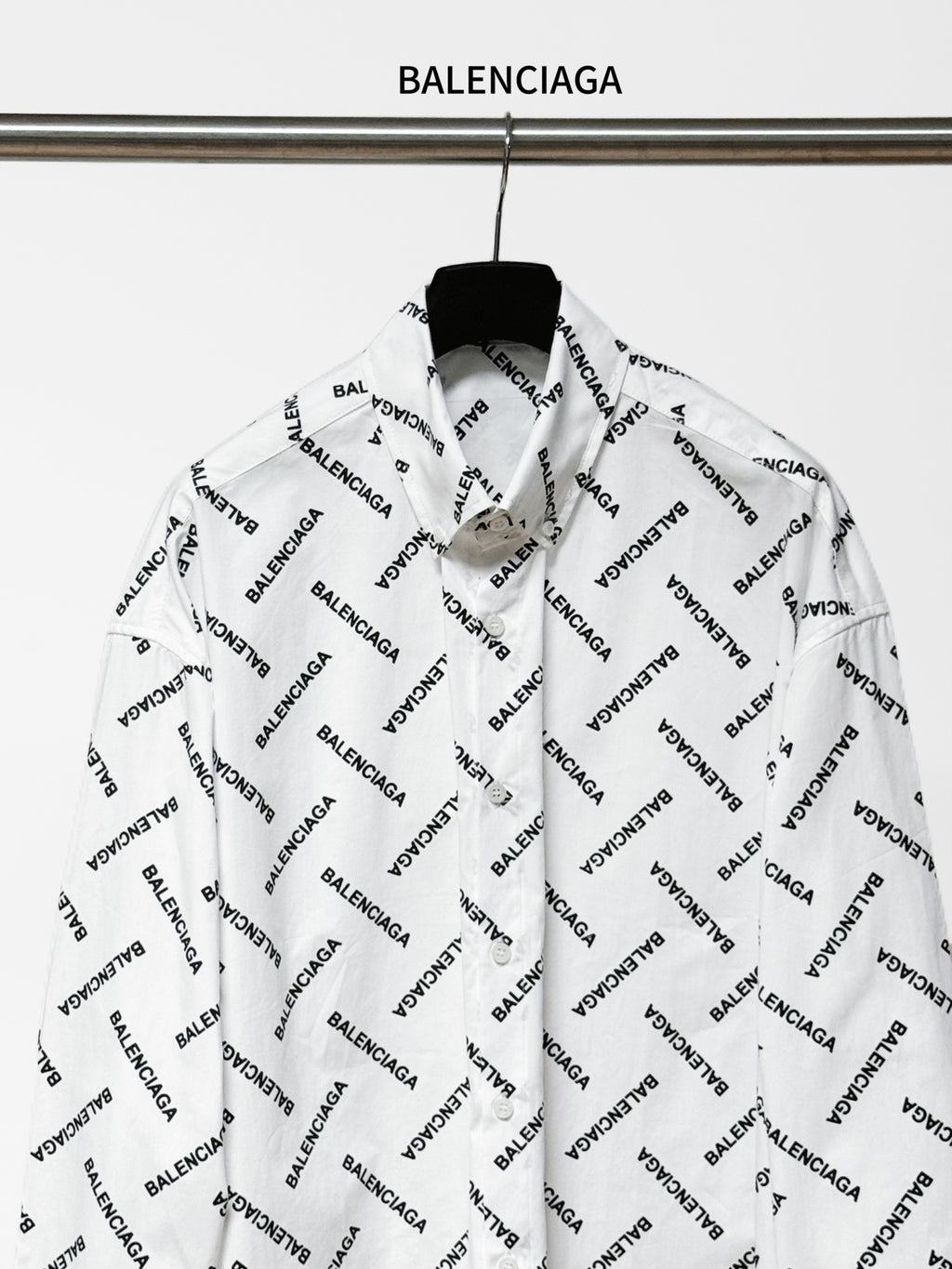White long-sleeve button-up shirt with black Balenciaga logo print, front view