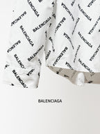 White long-sleeve button-up shirt sleeve and logo print detail, flat view