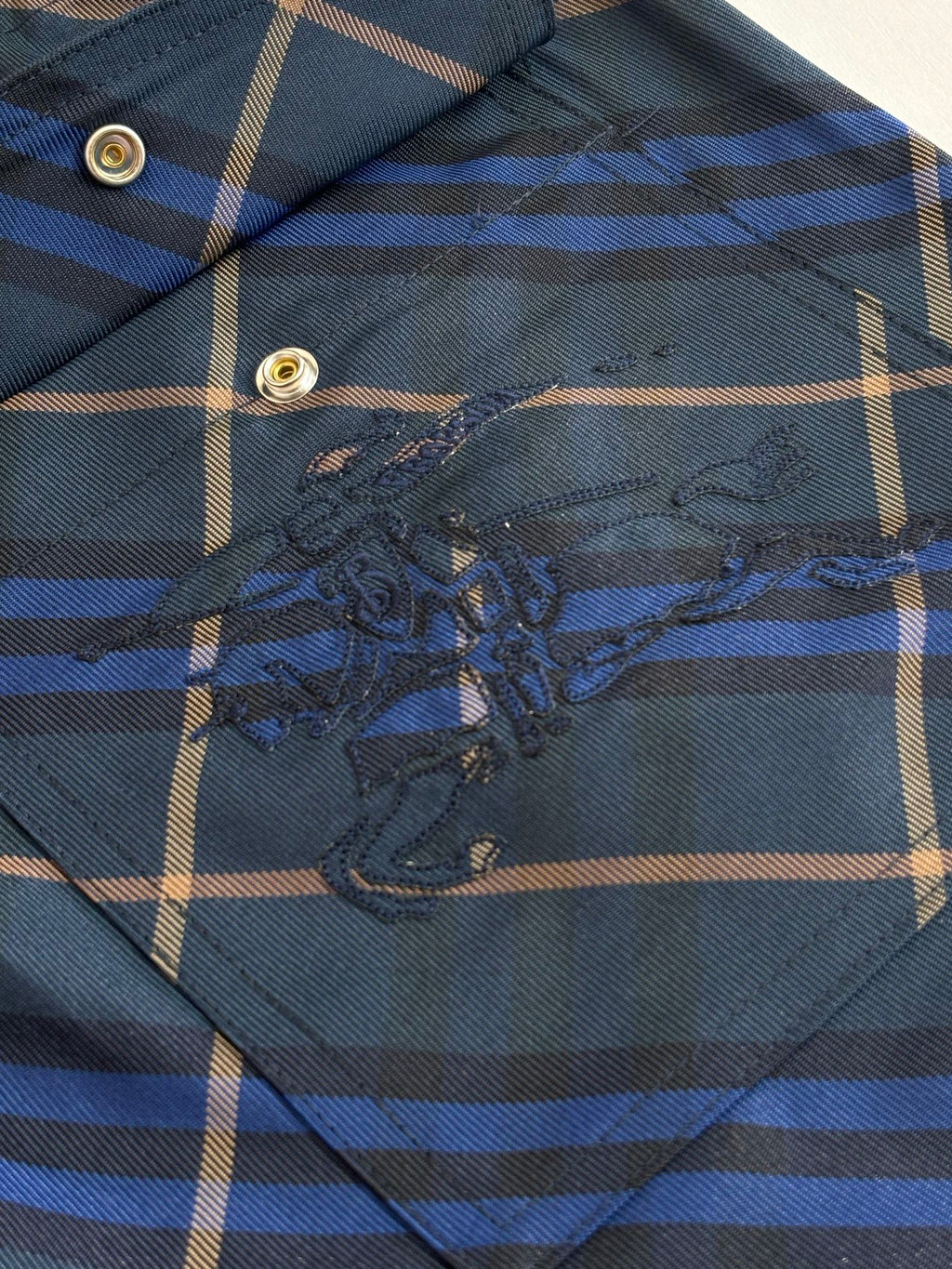 Navy plaid shorts embroidered patch detail on front panel, blue and tan grid