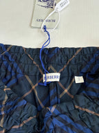 Dark blue and tan plaid pants with elastic waistband and Burberry logo label