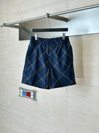 Navy plaid shorts with elastic waistband and drawstring, blue and tan check pattern