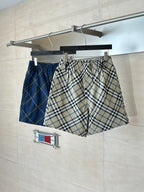Plaid pants on hanger, beige blue and black check pattern, elastic waistband and drawstring