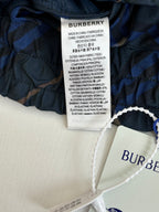Navy plaid pants interior with Burberry size/care label on waistband