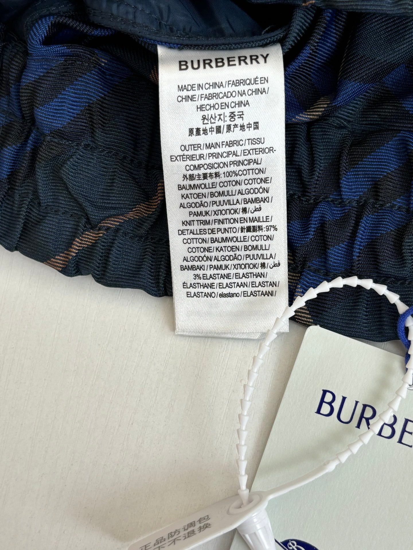 Navy plaid pants interior with Burberry size/care label on waistband