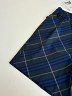 Navy plaid shorts side view with elastic waistband and drawstring details