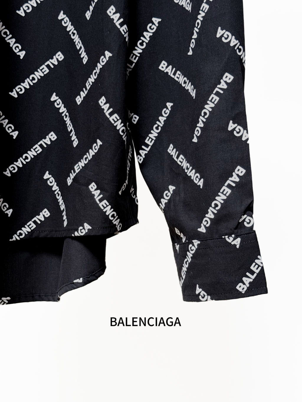Black shirt with Balenciaga logo pattern, cuffed sleeves and lower front view