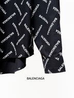 Black shirt with Balenciaga logo pattern, cuffed sleeves and lower front view