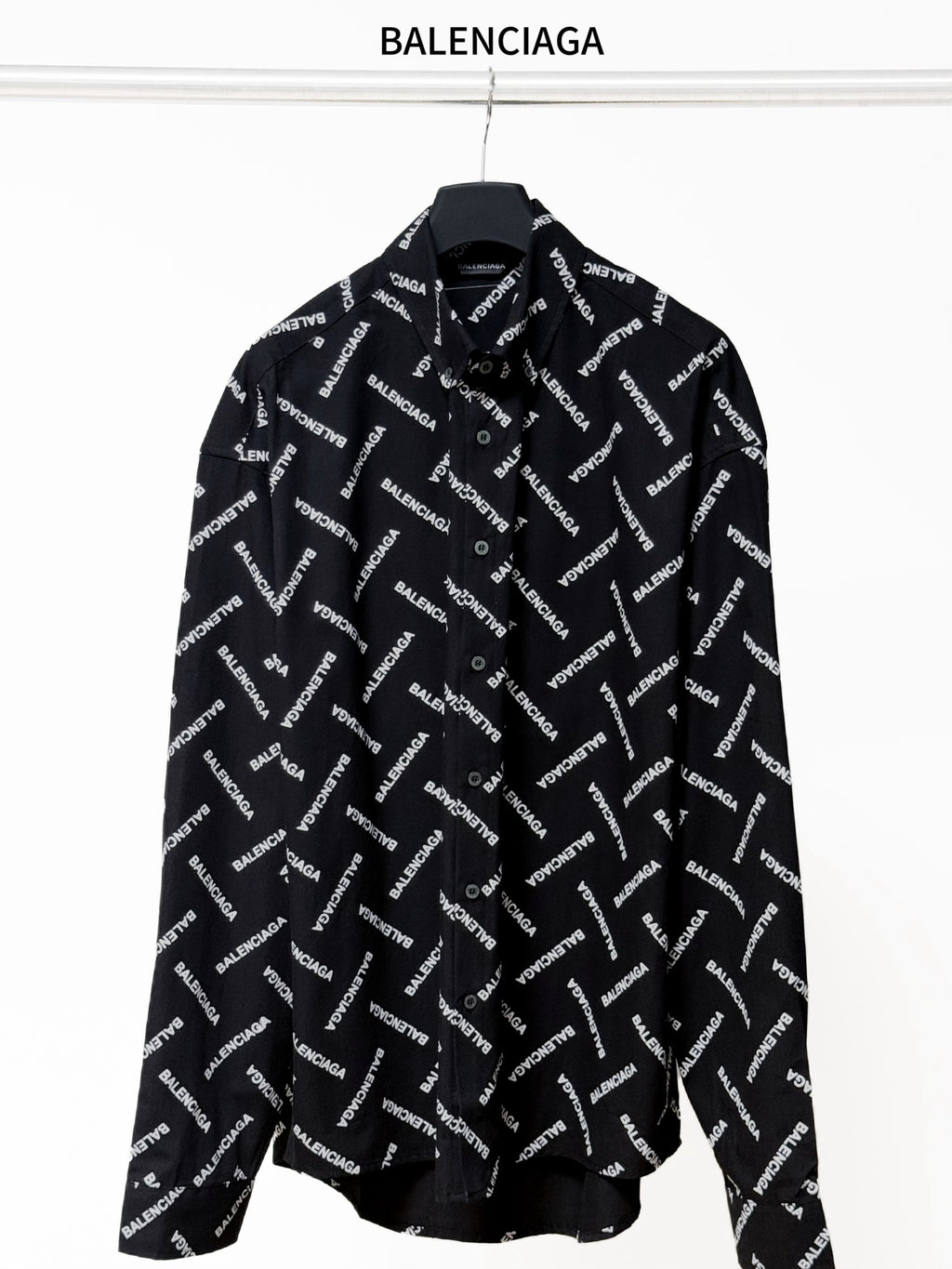 Black long-sleeve button-up shirt with allover Balenciaga logo print and pointed collar