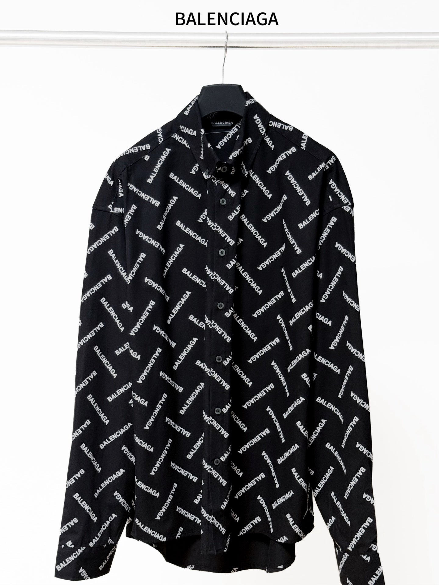 Black long-sleeve button-up shirt with allover Balenciaga logo print and pointed collar