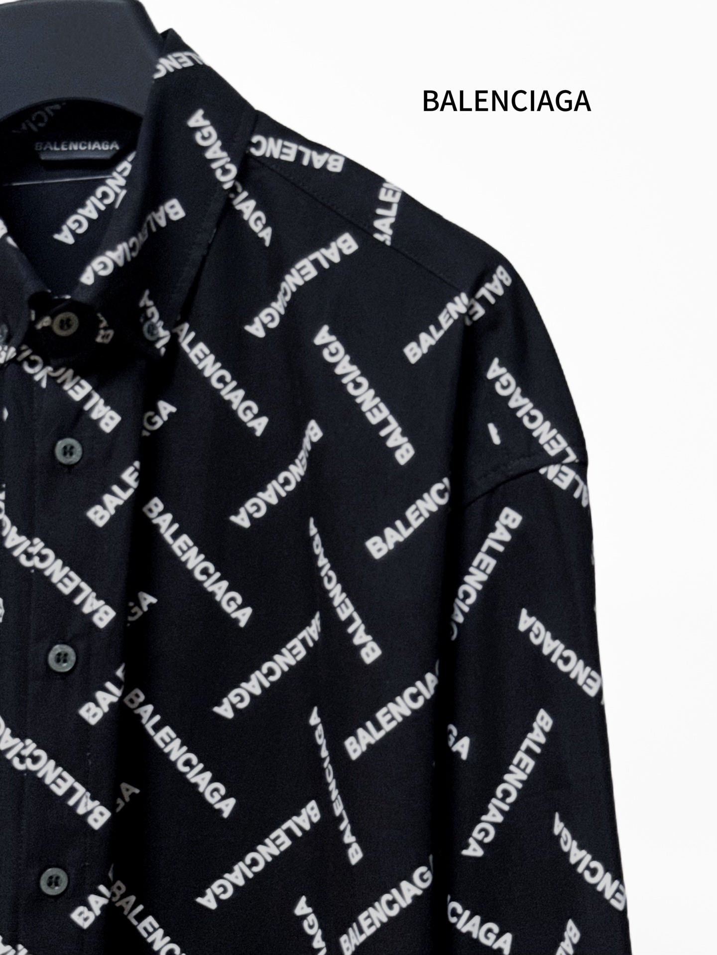 Black long-sleeve shirt sleeve with Balenciaga logo pattern and button cuff detail