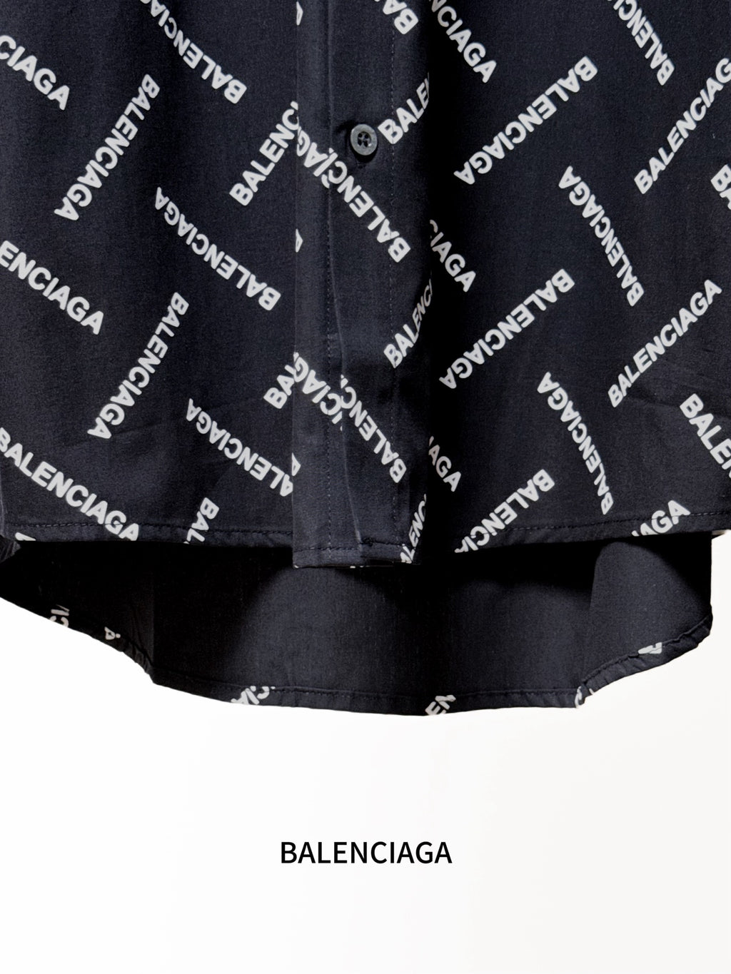 Black shirt hem with Balenciaga logo print and gathered lower edge detail