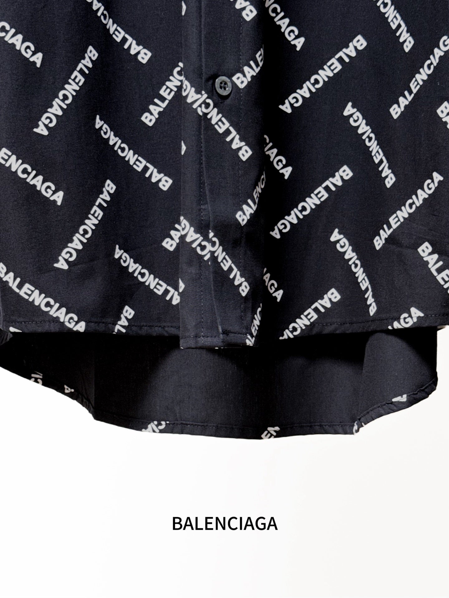 Black shirt hem with Balenciaga logo print and gathered lower edge detail