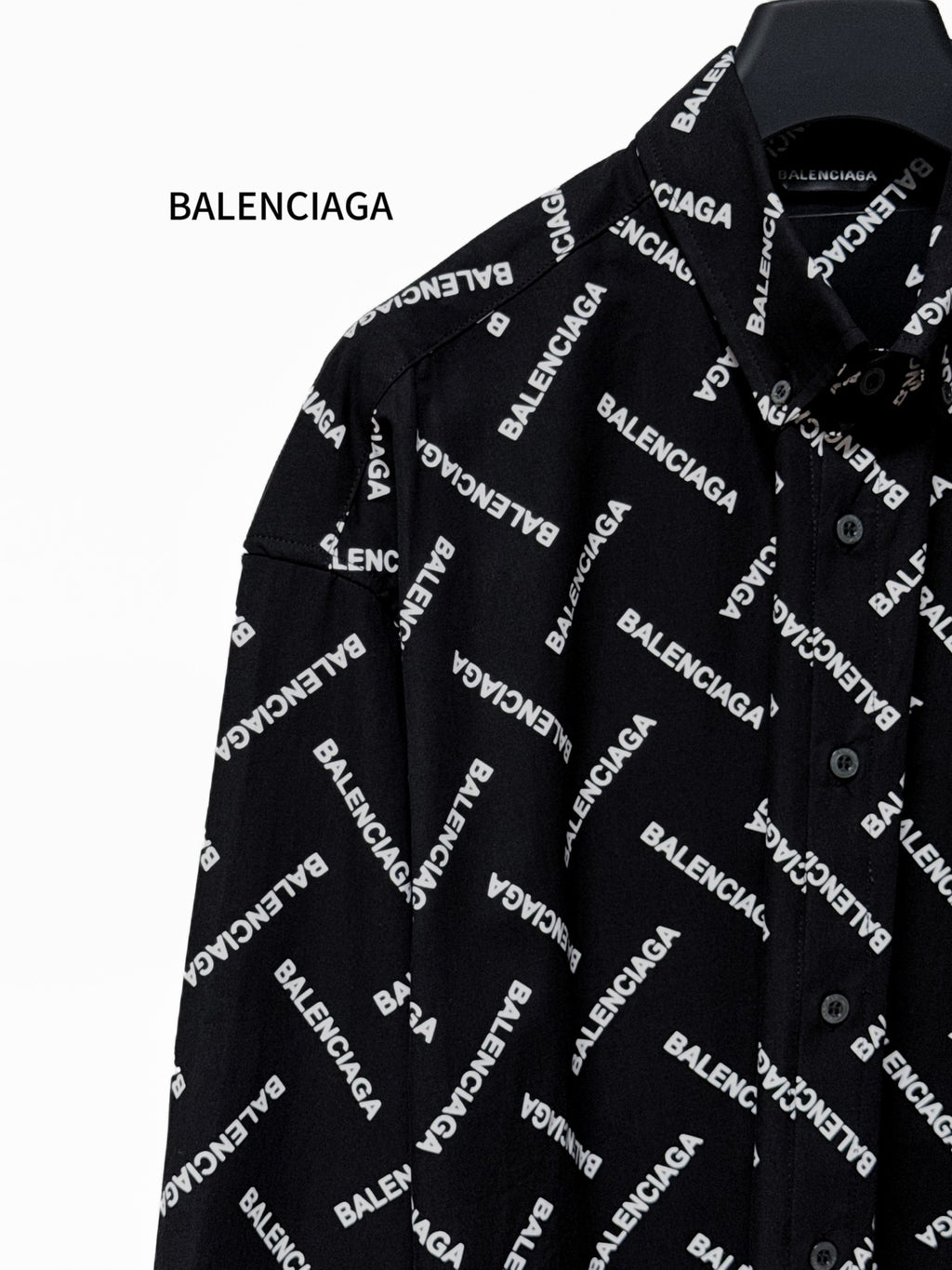Black button-up shirt with Balenciaga logo pattern, open collar and front placket