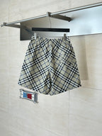 Plaid pants on hanger, elastic waistband with drawstring, beige blue and black checks