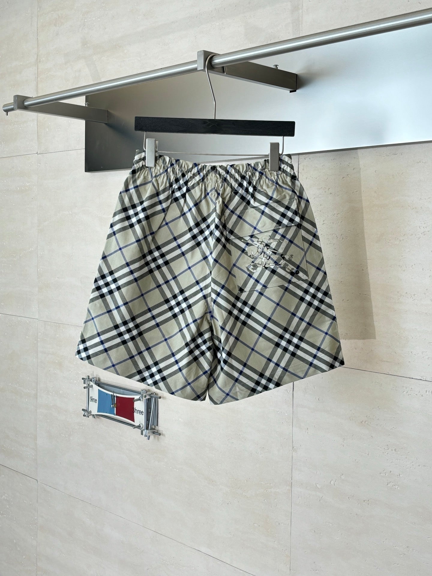 Plaid pants on hanger, elastic waistband with drawstring, beige blue and black checks