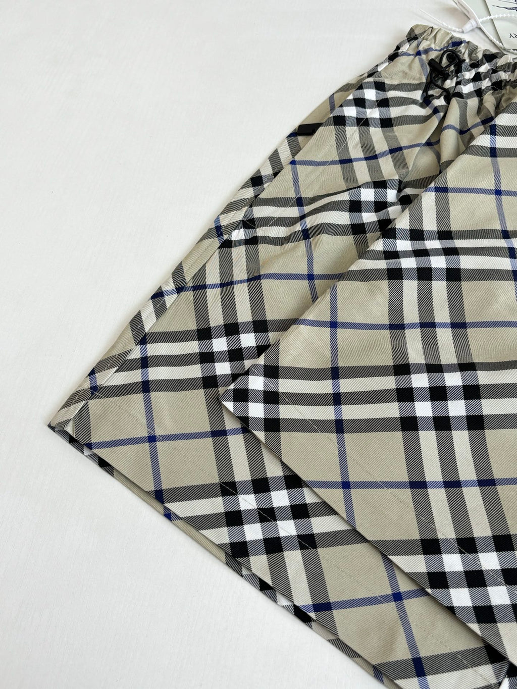 Plaid pants back view laid flat, gathered waist and drawstring, beige blue and black checks