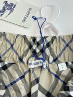 Kids checked pants with elastic waistband and blue drawstring tie, cream blue black