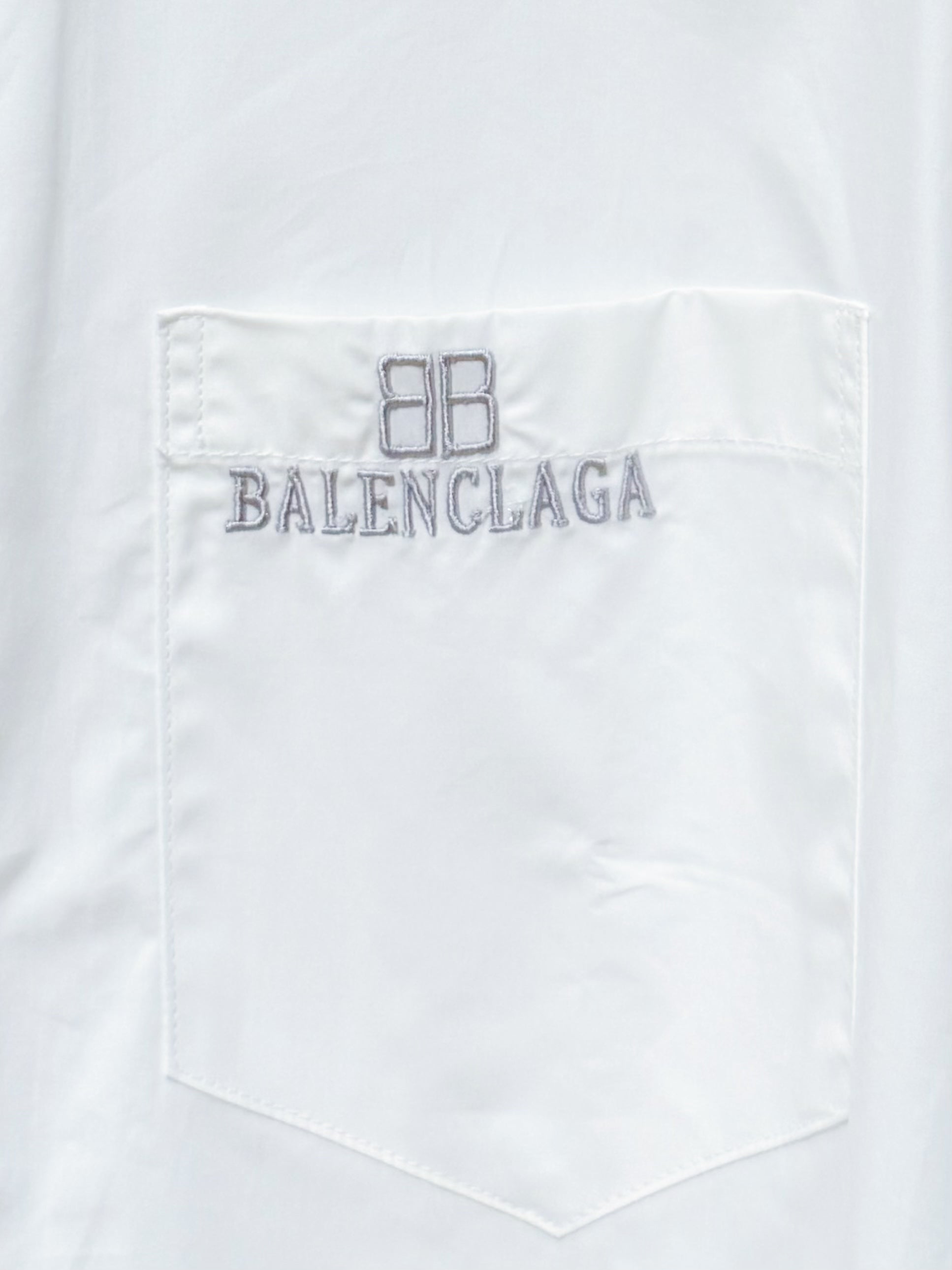 White chest pocket of long-sleeve button-up shirt with Balenciaga logo embroidery