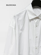 White long-sleeve button-up shirt with pointed collar and visible button placket