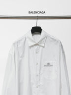 White long-sleeve button-up shirt front view with chest pocket and Balenciaga logo