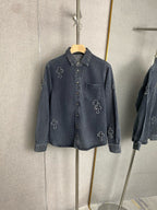 Dark blue denim jacket with button front and embroidered cross icons